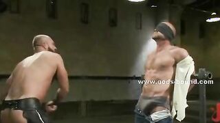 Large whips torment gay hunks bound on bondage devices spanking them roughly in hot video