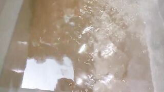 brunet playing with shower in bathroom