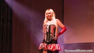 Big breasted stripper takes her clothes off and masturbates in front of the crowd