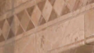 Wife gives a blowjob to her man as she rinses him