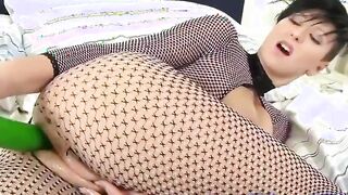 brunette babe with a huge green dildo