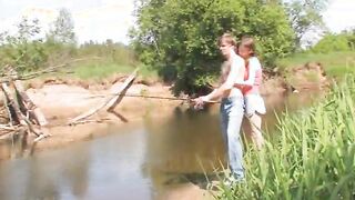 Young couple banging by the lake