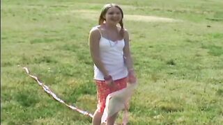 Cute 18yo teen Kitty flying a kite out in a field