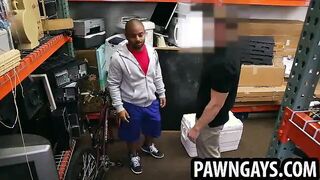 Ebony hunk sucking on a hard cock at the pawn shop