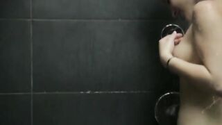 darkhair babe fingering cunt in a shower