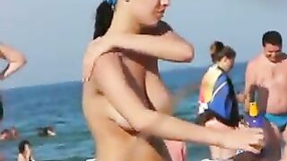 Topless Beach Babe Rubbing Lotion On Her Body