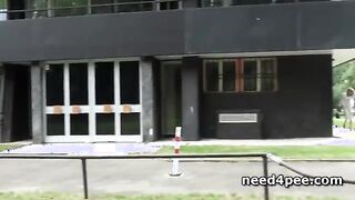 Blonde in leather jacket takes a pee standing