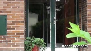 Blonde on heels pissing at a building entrance