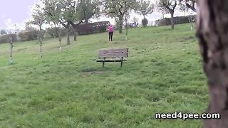 Hot brunette pissing on a bench in a park