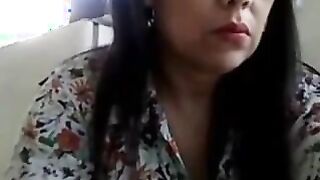 Carmen candid on webcam in her office