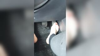 Sexy legs drive the car by pressing the pedals